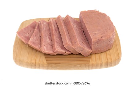 Several Thick Slices Of Canned Ham On A Wood Cutting Board.