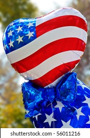Several toy helium balloons with the North American flag