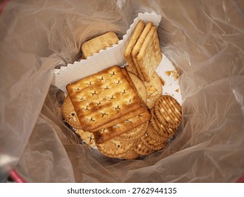 several types of biscuits in plastic-lined tins