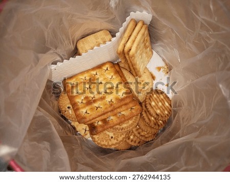 several types of biscuits in plastic-lined tins
