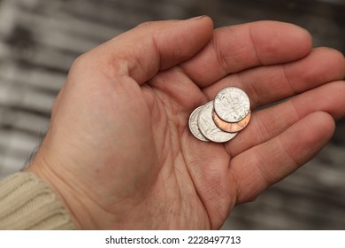 Several USA cent coins in hand