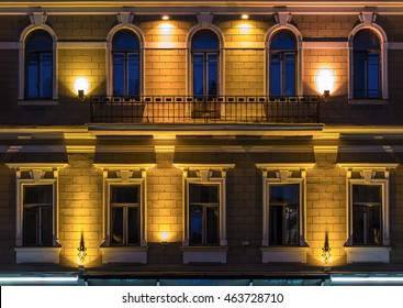 Several Windows In A Row And Balcony On Night Illuminated Facade Of Urban Office Building Front View, St. Petersburg, Russia
