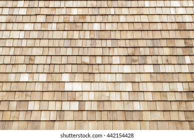 Several wood cedar shingles for siding or roofs.