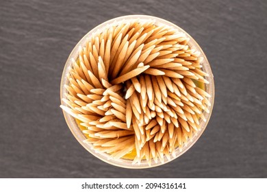 Several wooden toothpicks on a slate stone, close-up, top view.