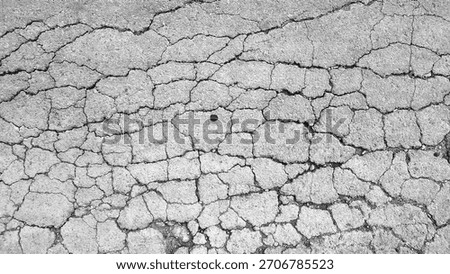 Severe Alligator Cracking Texture on Asphalt Road. Monochrome Grunge Background of Damaged Pavement. Aged and Broken Concrete Surface Detail