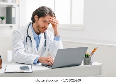 Severe Diagnosis. Worried Male Doctor Looking At Bad Test Results On Laptop At Office, Free Space