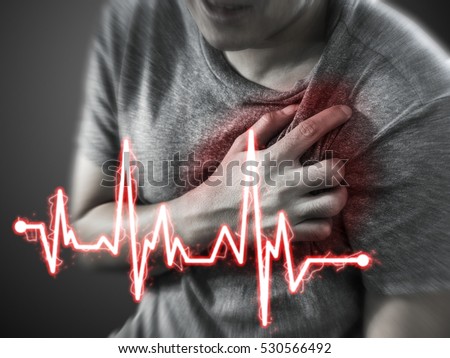 Severe heartache, man suffering from chest pain, having heart attack or painful cramps, pressing on chest with painful expression.