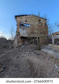 Severe structural decay of a multi-story brick edifice, Vidnava, with nature's reclamation evident.