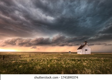 A severe thunderstorm approaches an old abandoned church in the countryside during the late afternoon in Colorado. 