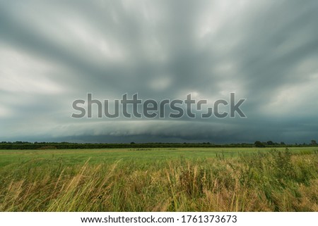 Severe thunderstorm with shelf cloud over the dutch landscape