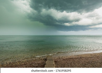 Severe weather with thunderstorms, heavy rain showers and strong winds develop rapidly at Desenzano del Garda city, lake Garda, Brescia, Lombardy, Italy