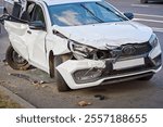 Severely damaged , broken headlights after road incident. Car with severe damage, front-end and rear-end collision aftermath. Car destruction, intense impact from traffic accident.