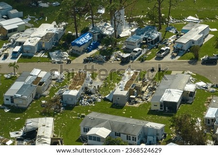 Severely damaged houses after hurricane Ian in Florida mobile home residential area. Consequences of natural disaster