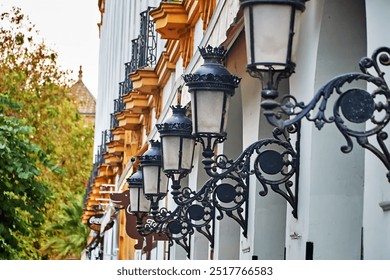 Sevilla, España-octubre,18 2023;Elegant wrought-iron street lamps on a traditional Sevillian building facade, showcasing intricate craftsmanship and historic city charm. - Powered by Shutterstock