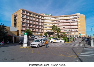 Seville, Andalusia, Spain; February 7th 2021: Main building of the Virgen del Rocio hospital in Seville (Andalusia, Spain). Emergency access with taxi rank.