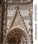 Seville cathedral gate and statues of saints. The Assumption Gate of the Cathedral of Seville (Spanish: Catedral de Santa Maria de la Sede) in Spain, the main portal of the west facade.