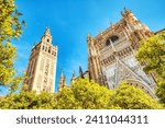 Seville Cathedral and Giralda Tower during Beautiful Sunny Day in Seville, Spain     