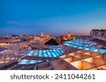 Seville City Skyline view with Illuminated Space Metropol Parasol in the Foreground at Dusk, Seville, Spain