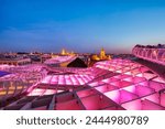 Seville City Skyline view with Illuminated Space Metropol Parasol in the Foreground at Dusk, Seville, Spain