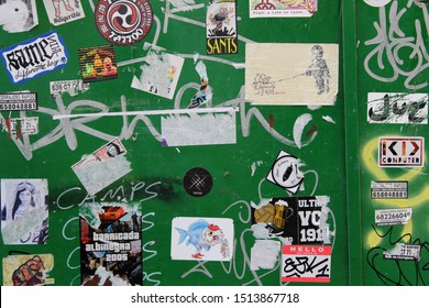 SEVILLE, SPAIN - 21 JULY 2019: Green Wall With Many Old Stickers