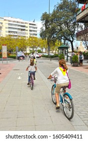 Seville, Spain - Apr 25, 2010: Children Bike Ride. Cycling Through The  Remedios Neighborhood In Seville, Andalusia, Spain