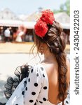 Seville, Spain - April 23, 2023 Beautiful woman wearing flamenco dress. April Fair Seville, Andalusia