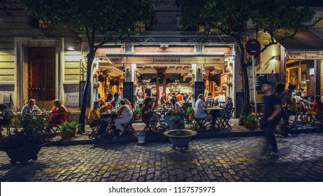Seville, Spain - July 14th, 2018: Busy bar and restaurant on Calle Mateos Gago servicing Spanish style tapas to locals and tourists well into the late hours in the historic centre of Seville