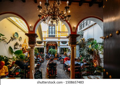 Seville, Spain - Sept 10, 2019: Busy Restaurant Courtyard In Seville, Spain With Traditional Moorish Arches