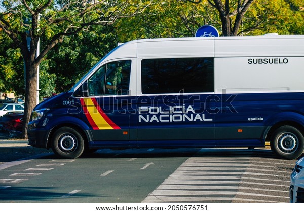 Seville Spain\
September 22, 2021 Police car patrolling in the streets of Seville\
during the coronavirus outbreak hitting Spain, wearing a mask in\
the street is not\
mandatory