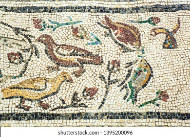 Seville,Spain - April 11,2019: A Beautiful Complex Ancient Roman Mosaic Pattern From 2nd Century In Background