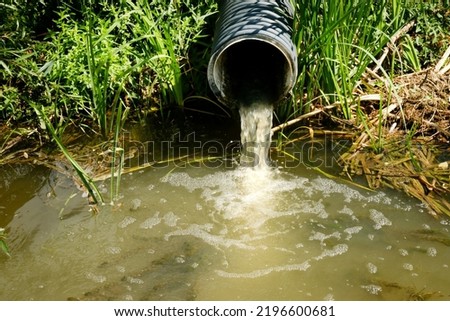 Sewage pipe discharges sewage and wastewater into the river. Environmental pollution