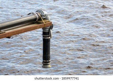 Sewage Pipe With Open End Over Water Surface Of A Lake.
