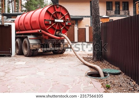 Sewage Tank truck. Sewer pumping machine. Septic truck. Pipe in the drainage pit. Pumping out sewage from a septic tank. Septic tank service