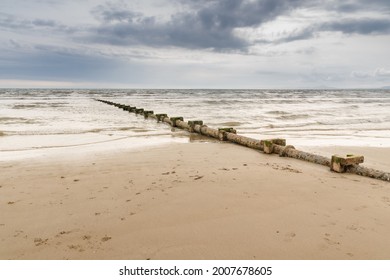 Sewage Or Waste Water Discharge Pipe Leading Out To Sea On A Beach In The UK 