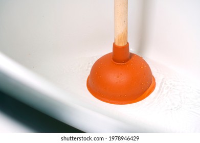 Sewer Blockage Cleaning With A Plunger. Clogged Pipes In The Bathroom.