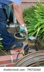 Sewer Cleaning. A Plumber Uses A Sewer Snake To Clean Blockage In A Sewer Line. 