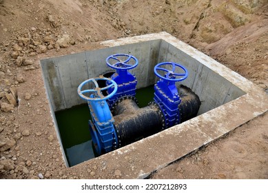 Sewer construction. Gate valves in valve pit of underground piping networks. Laying water system pipeline at construction site. Water supply pipeline, pipes in trench. Sanitary sewer. Sewage Pipeline 