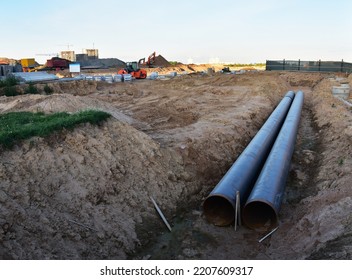 Sewer Construction. Laying Of Storm Sewer Pipes At The Construction Site. Installation Of Water Main And Sanitary Sewer. Ground Water Drainage System Pipes. 