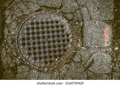 A Sewer Grate In Pavement