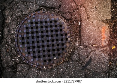 A Sewer Grate In Pavement