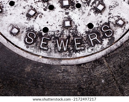 Sewer man hole cover of an iron lid for access to sewer lines
