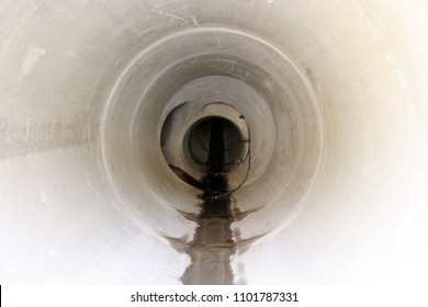 Sewer Pipe or Storm Drain. Inside a sewer pipe or storm drain.
