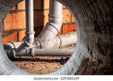 Sewer pipes in home basement. System of gray sanitary pipes when building a house. Sewer installation for sewage disposal - Shutterstock ID 2291881639