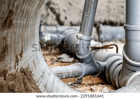 Sewer pipes in home basement. System of gray sanitary pipes when building a house. Sewer installation for sewage disposal