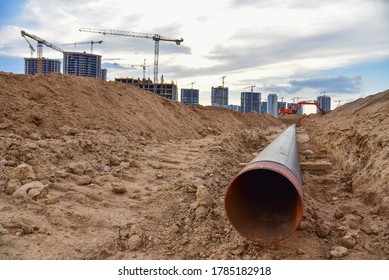 Sewer Pipes For Laying An External Sewage System At A Construction Site. Sanitary Drainage System For A Multi-story Building. Civil Infrastructure Pipe, Water Lines And Storm Sewers. Tower Crane Work