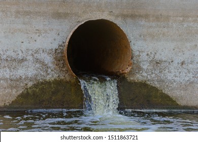 Sewer Water Spills Out Of An Old Rusty Pipe