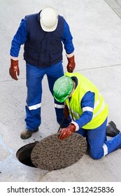 Sewerage Utility Workers Moves The Manhole Cover To Cleaning The Sewer Line