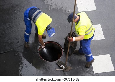 sewerage workers  draining the sewer line