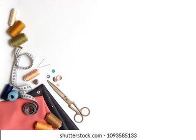 Sewing Accessories And Fabric On A White Background. Sewing Threads, Needles, Pins, Fabric, Buttons And Sewing Centimeter.
 Top View, Flatlay 