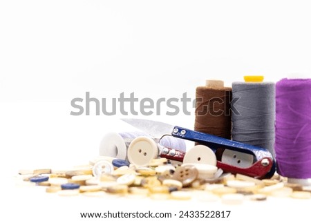 Sewing accessories, mending clothes, colorful threads, measuring tape, buttons and scissors, selective focus, copy space